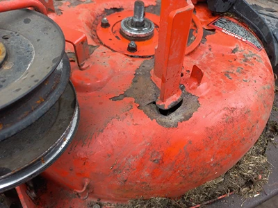a lawnmower deck before repair