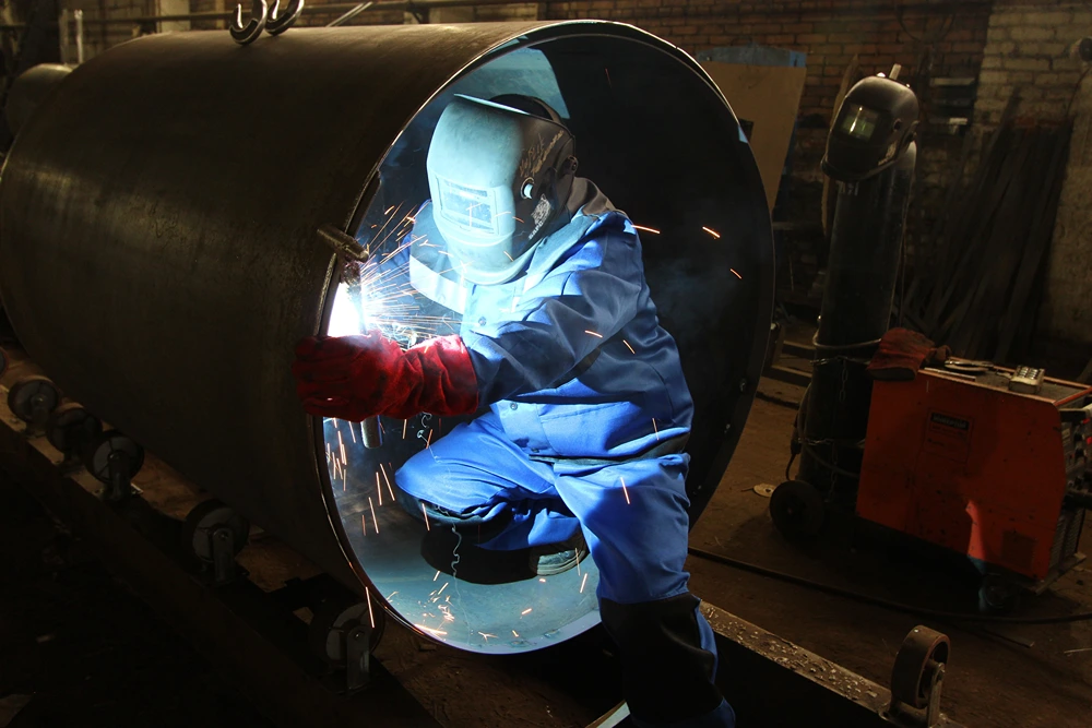 a man welding inside a pipe
